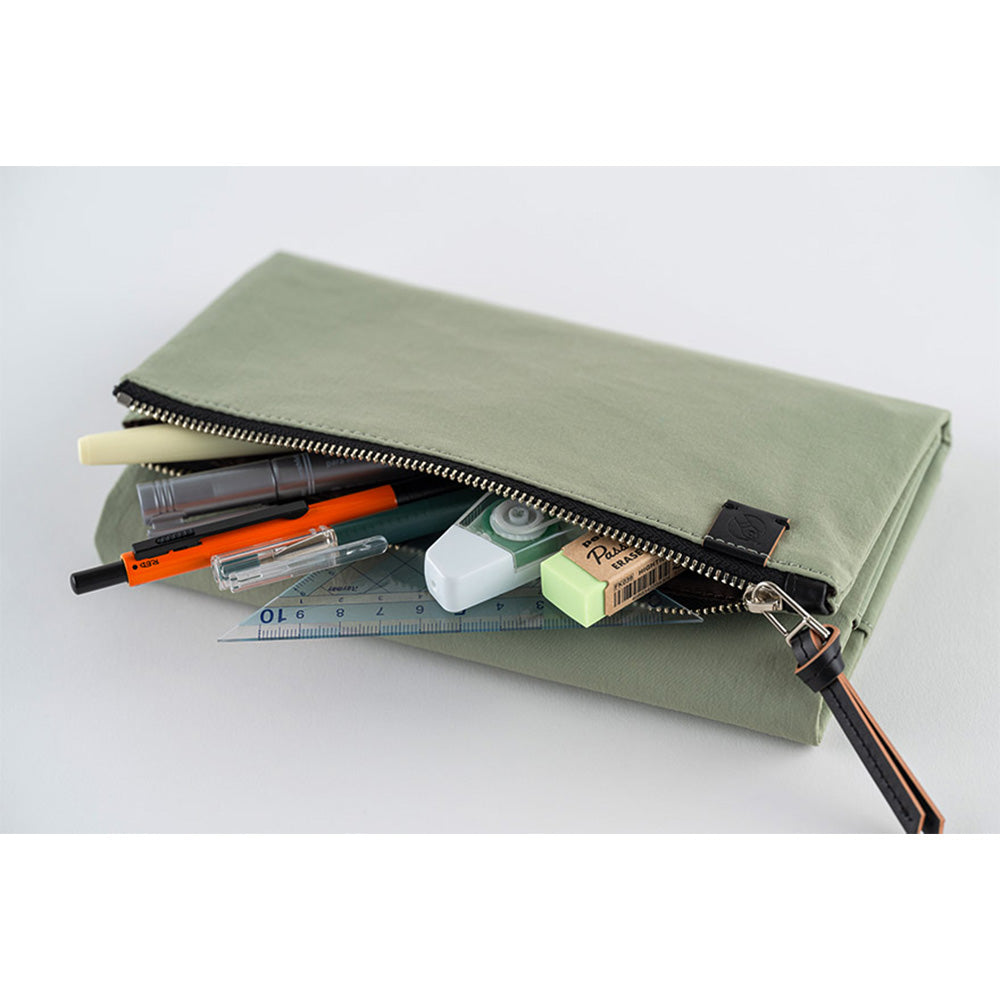 Open Hobonichi Tragen cover holding pens, tape dispenser, and ruler