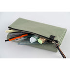 Open Hobonichi Tragen cover holding pens, tape dispenser, and ruler