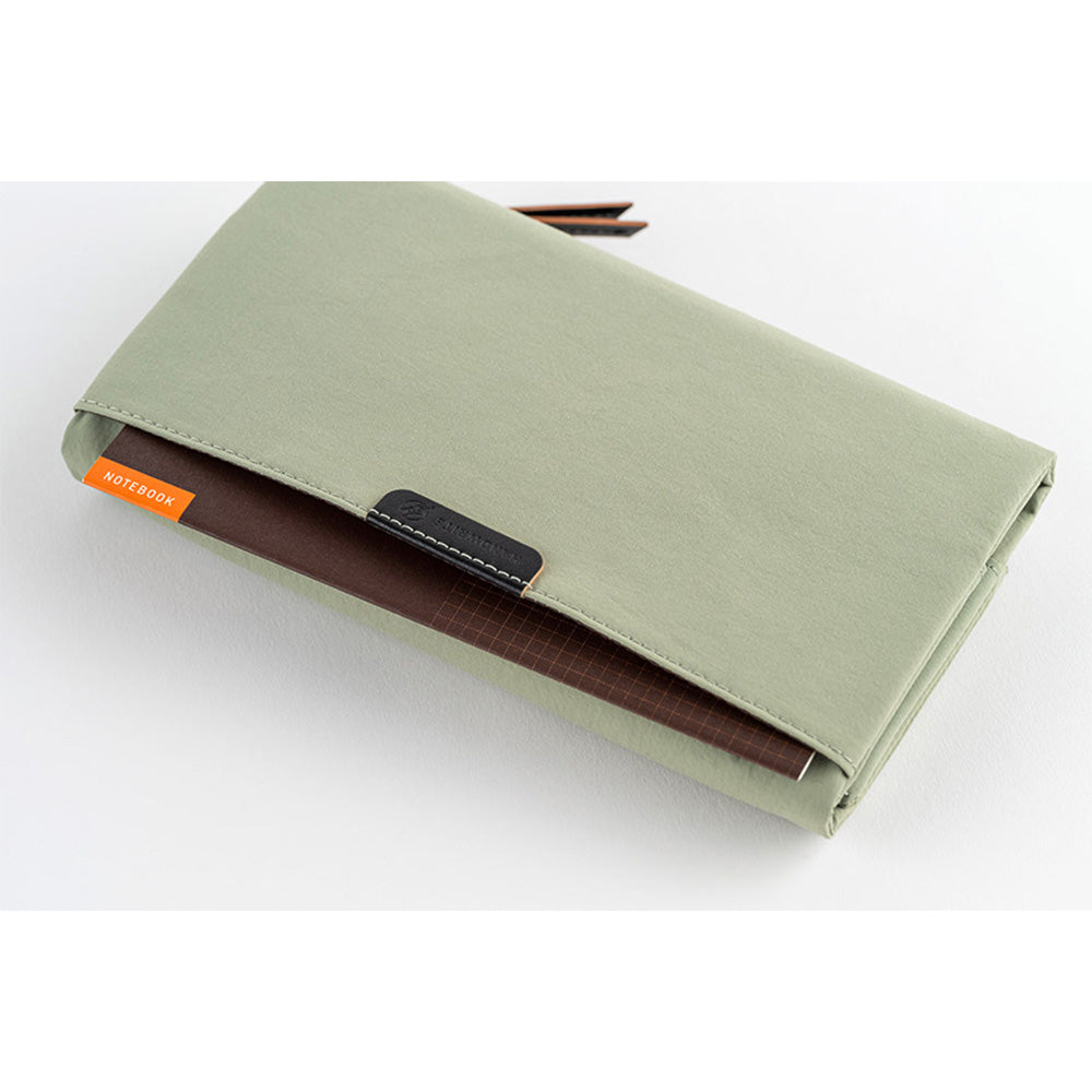Hobonichi Tragen cover holding brown grid notebook inside