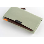 Hobonichi Tragen cover holding brown grid notebook inside