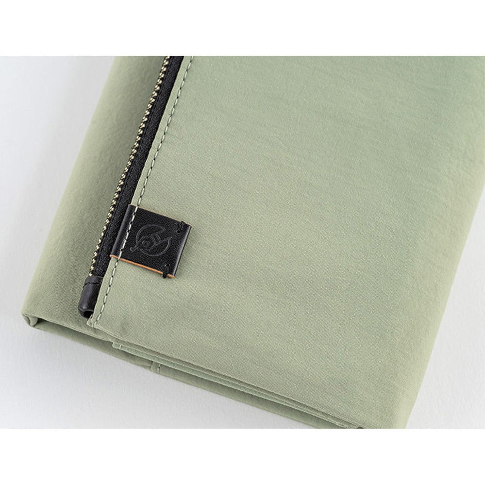 Lower corner detail of Hobonichi Tragen cover with logo tag