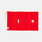 Open red tri-fold cover interior with circular leather patch detail
