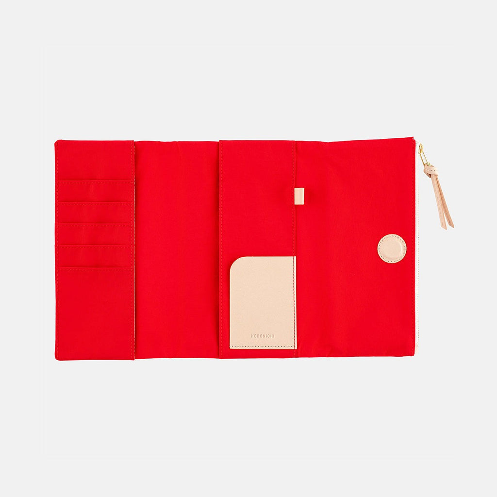 Top-down view of fully open red tri-fold organizer layout