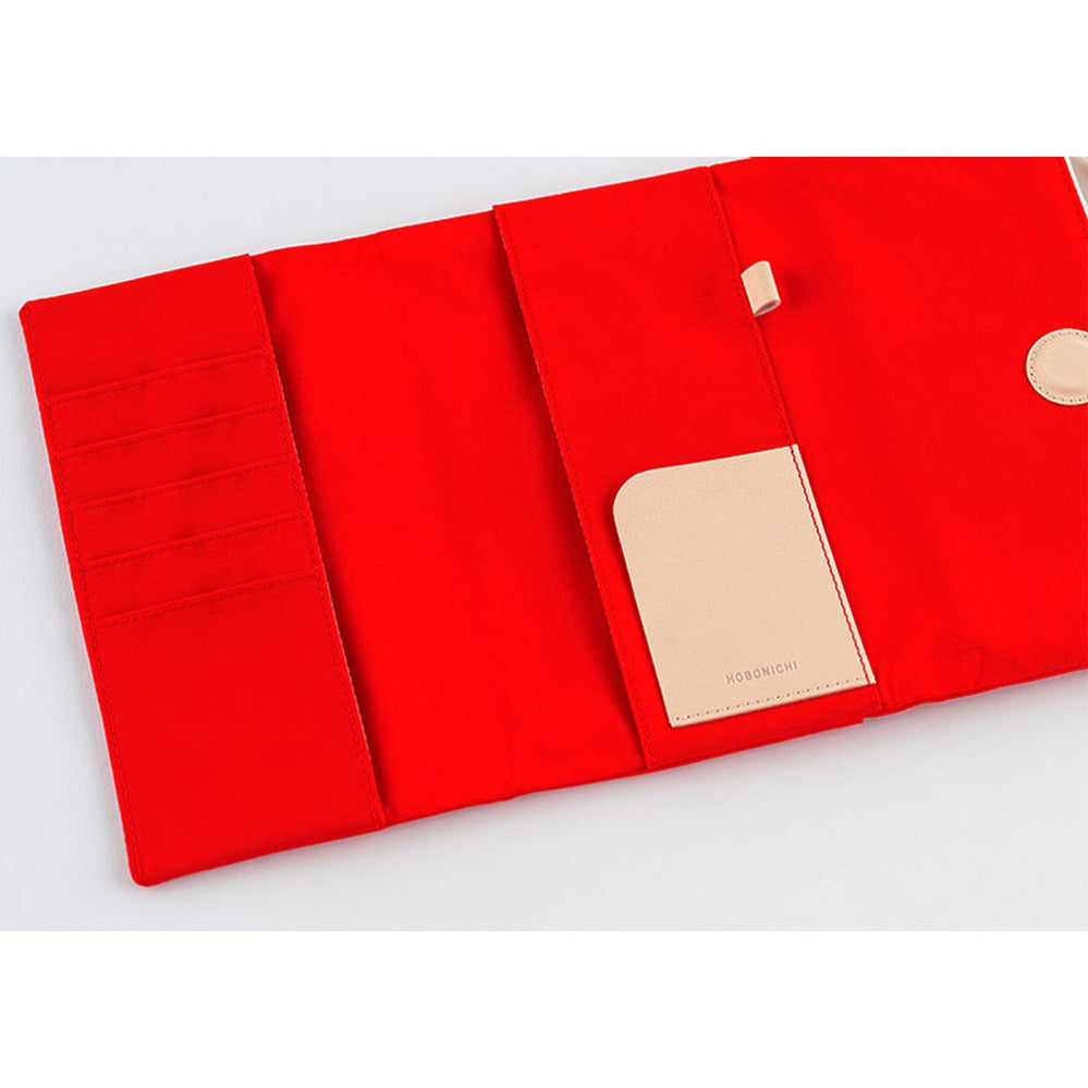 Red tri-fold cover interior with vertical pockets and card slot
