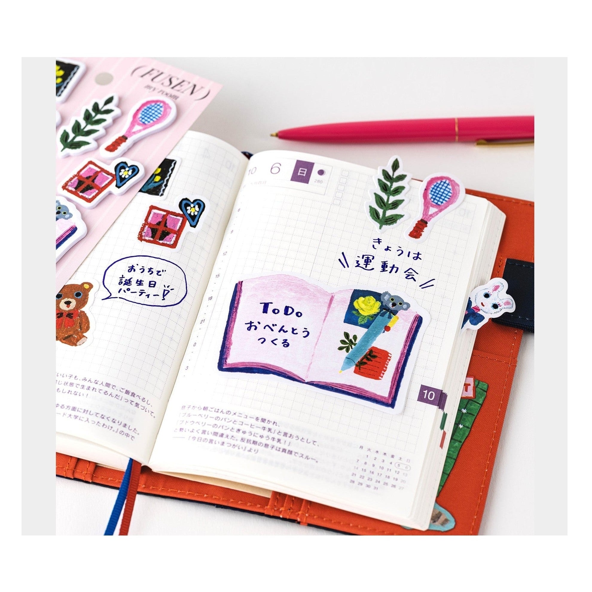 Hobonichi Techo sticky note tabs with Yumi Kitagishi illustrations on grid notebook
