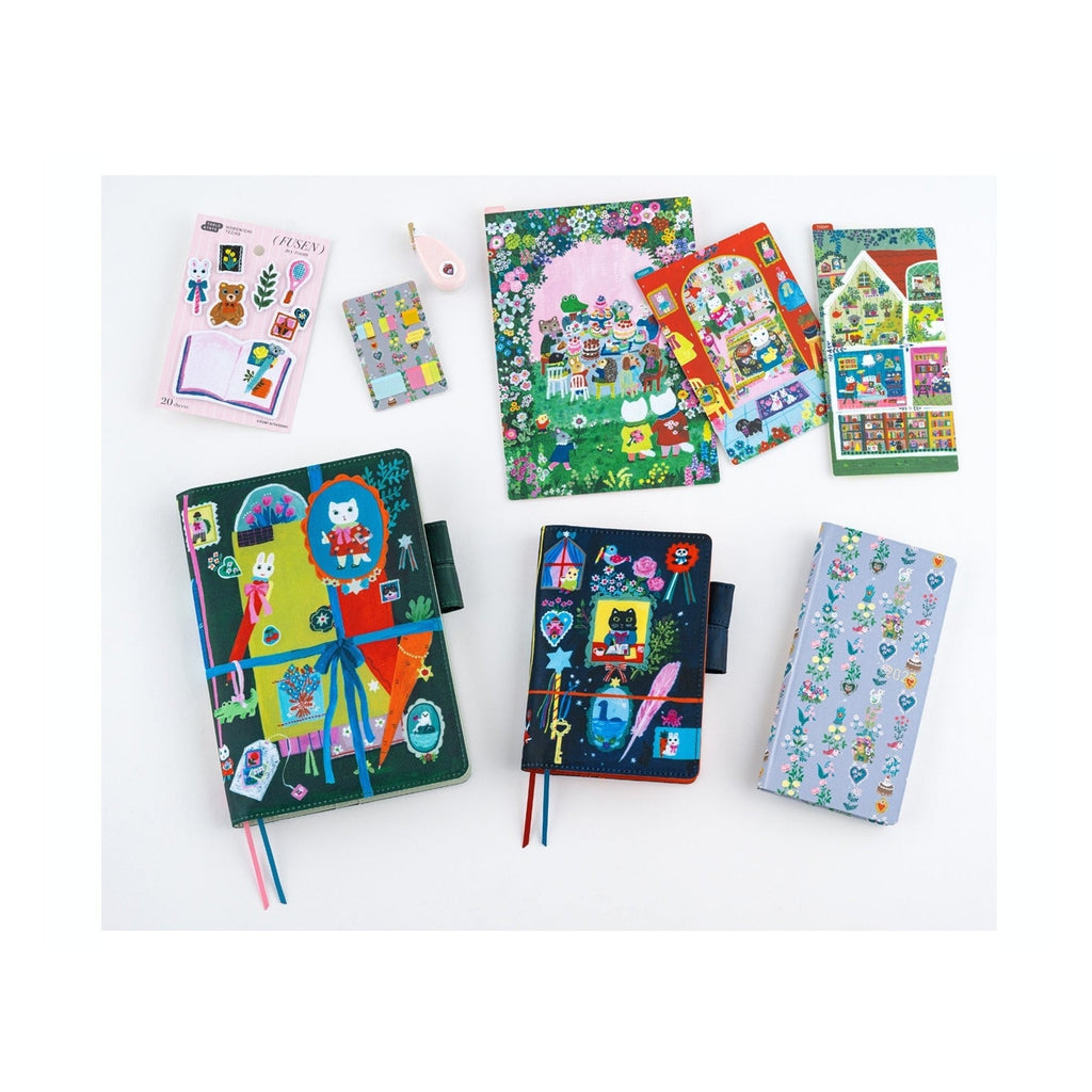Whimsical stationery collection featuring Yumi Kitagishi illustrated notebooks and sticker sheets