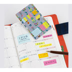 Yumi Kitagishi Hobonichi translucent sticky notes in floral holder with pastel colors on planner