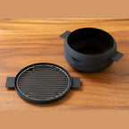 Disassembled black iron deep frying pot set with wire rack lid