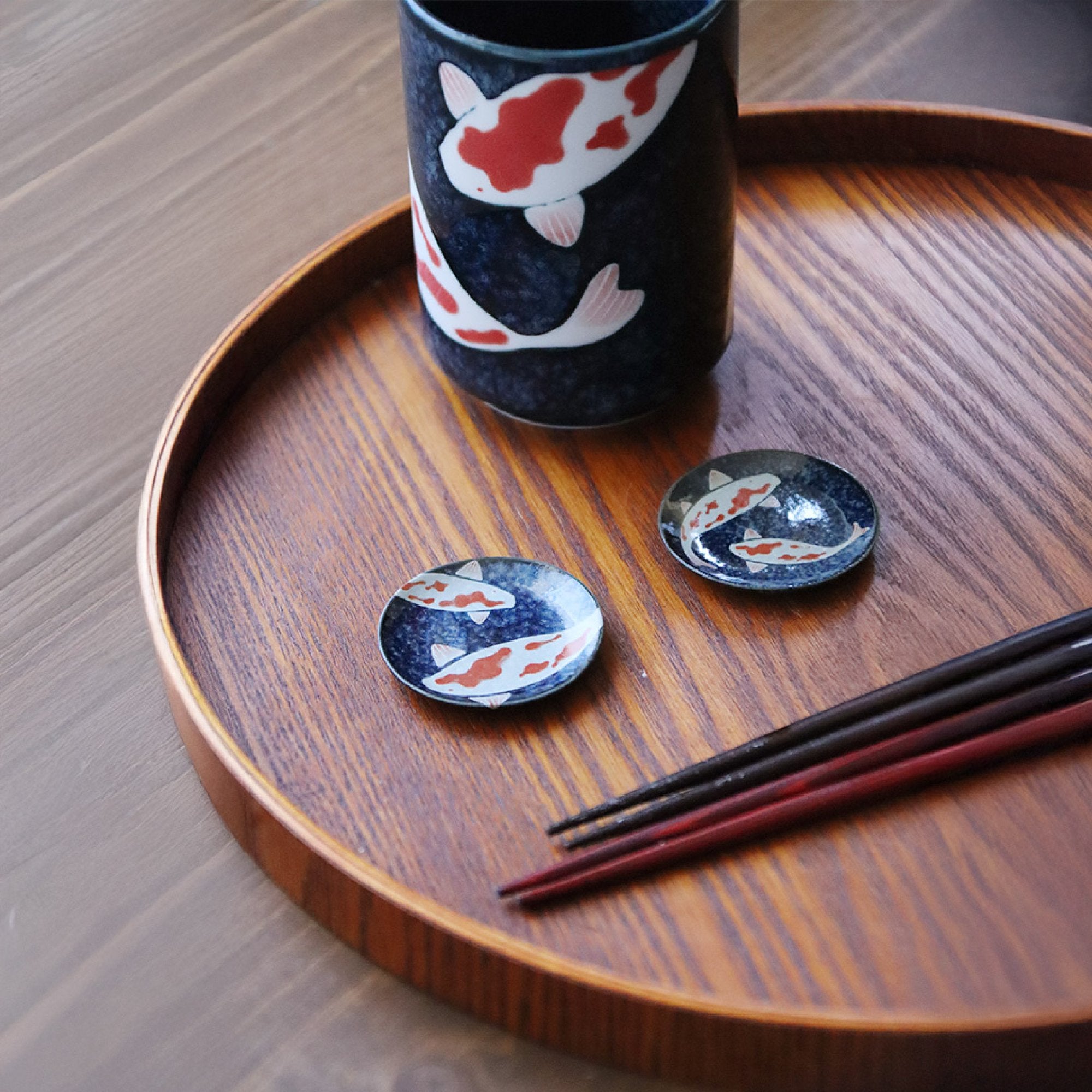 Koi chopstick rests styled on a wooden tray