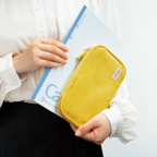 Open yellow corduroy Kokuyo Pancase resting on Campus notebook demonstrating book-like opening