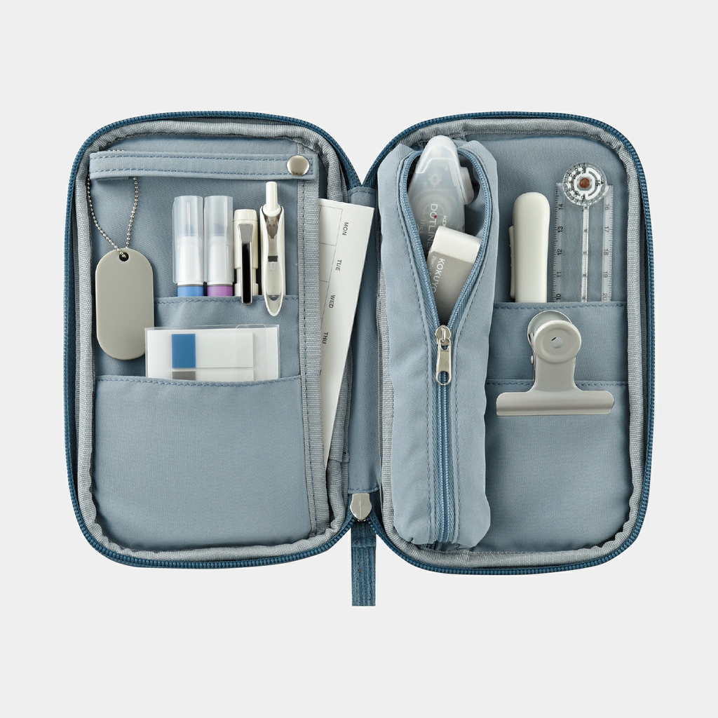 Open light blue Kokuyo Pancase with weekly planner insert and vertical tape dispenser pocket
