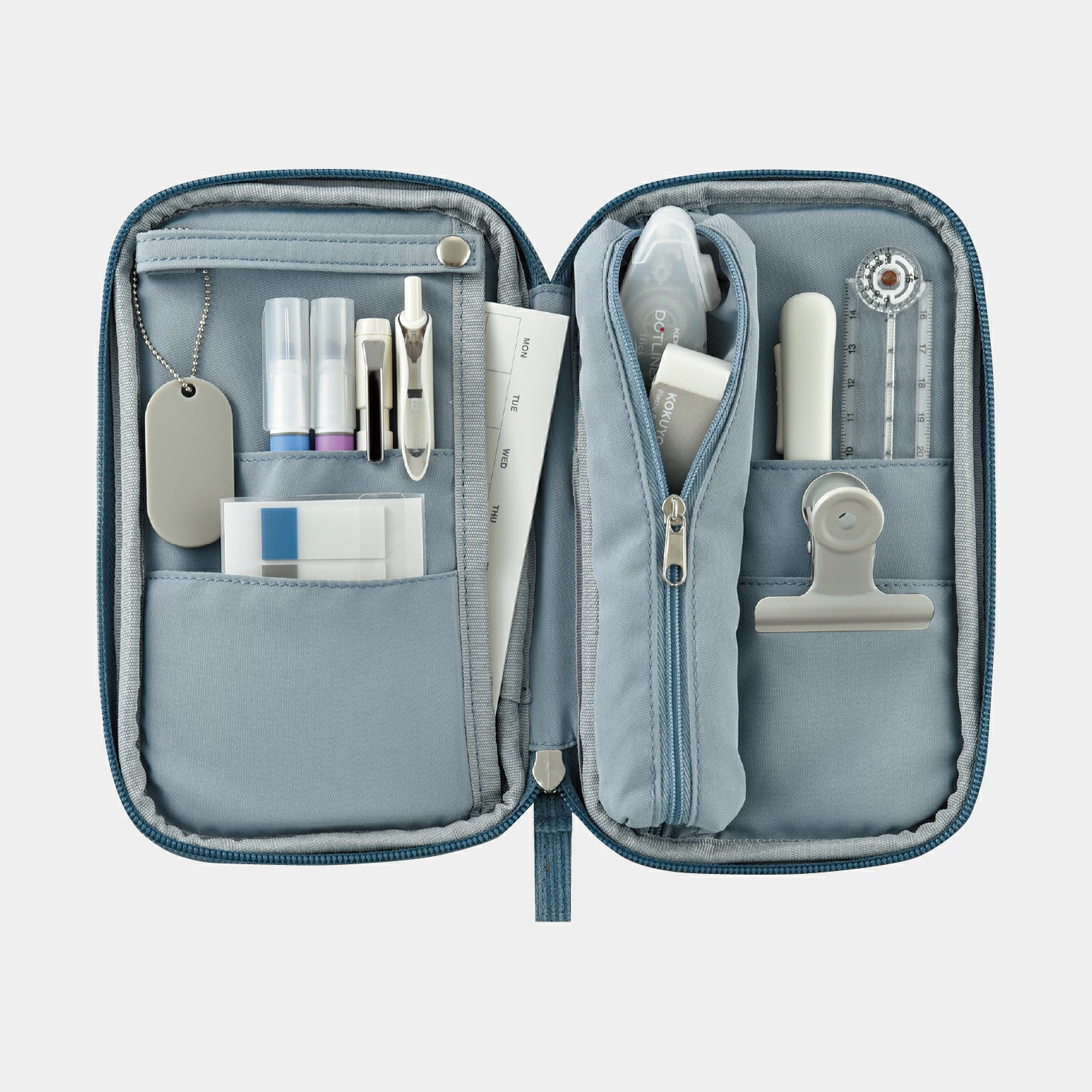 Open light blue Kokuyo Pancase with weekly planner insert and vertical tape dispenser pocket