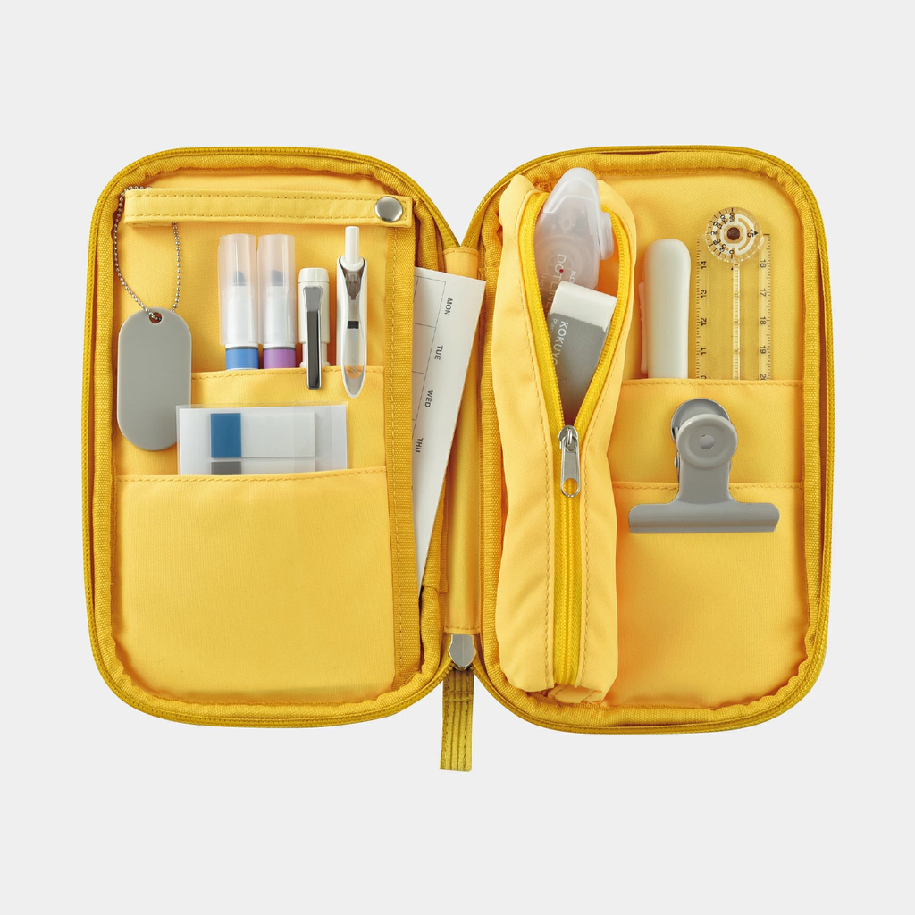 Open mustard yellow Kokuyo Pancase with days of week insert and organized pen compartments