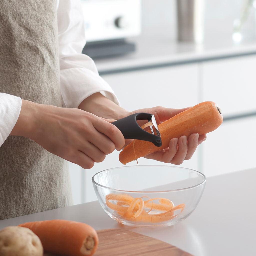 Marna black Y-shaped vegetable peeler slicing carrot in kitchen