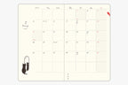 Midori diary open two-page monthly calendar grid for January 2027 with red highlighted dates
