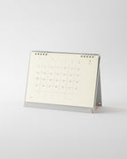 Midori MD Desk Calendar 2027 standing on its grey base with silver double ring binding