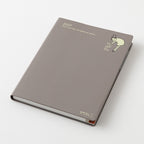 High-angle shot of closed Midori Ojisan diary showing spine and tabbed index