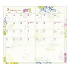 February 2027 calendar page in Midori diary featuring blue pansies and purple flower watercolor illustrations