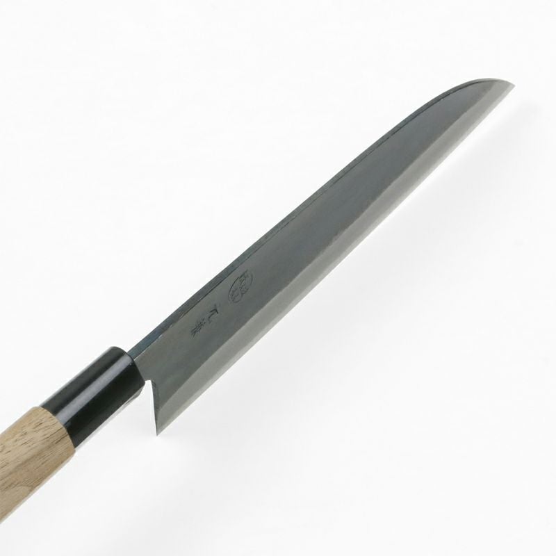 Close-up of Motokane Santoku knife handle ferrule and stamped blade details