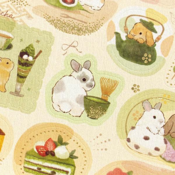 Close-up of textured crepe paper sticker sheet showing gold foil matcha and rabbit details