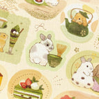 Close-up of textured crepe paper sticker sheet showing gold foil matcha and rabbit details