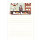 Otter behind shop counter displaying pastries on hosho washi letter pad