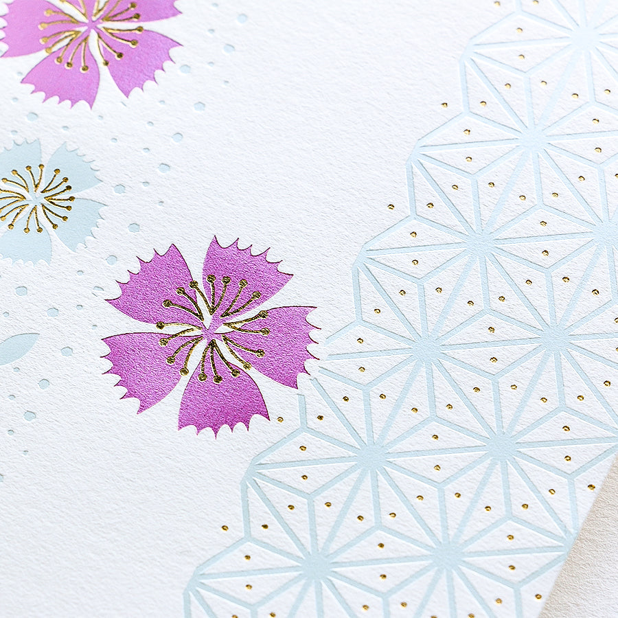 Macro detail of raised gold foil dots and serrated petals on traditional Japanese shugi-bukuro envelope