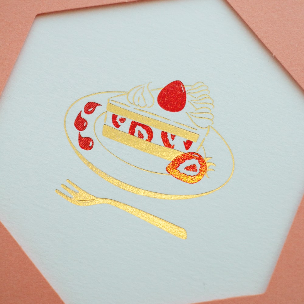 Close-up of dimensional foil stamping on Rokkaku strawberry shortcake card