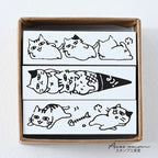 Lazy cat border stamp designs on rubber faces inside kraft box