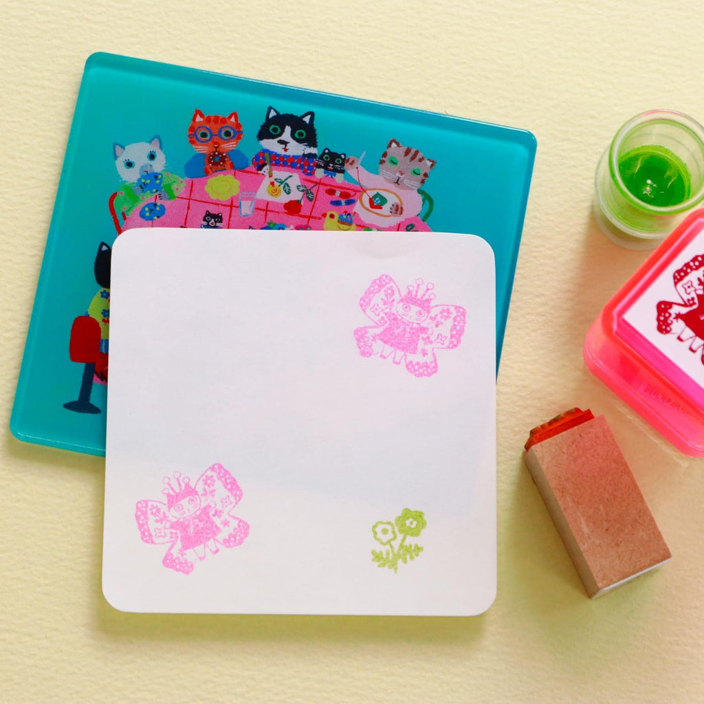 Teal cat stamp mat showing crisp stamped butterfly and flower impressions with ink pads