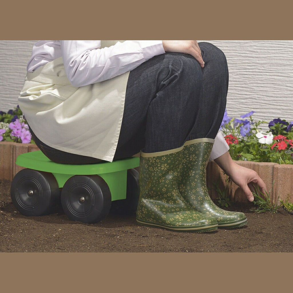 Person using lime green sit-and-roll garden stool in flowerbed for gardening