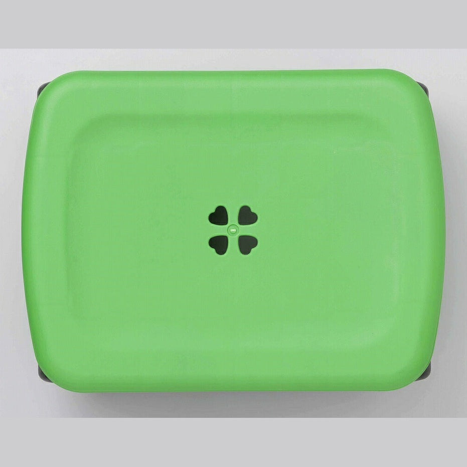 Lime green Shimomura Kihan garden stool with clover motif seat and black wheels