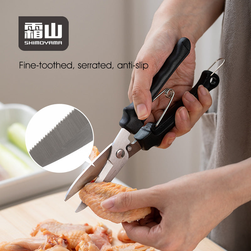 Shimoyama kitchen scissors with serrated blades cutting chicken wings