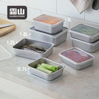 Shimoyama aluminum food storage containers in various sizes stacked on marble countertop