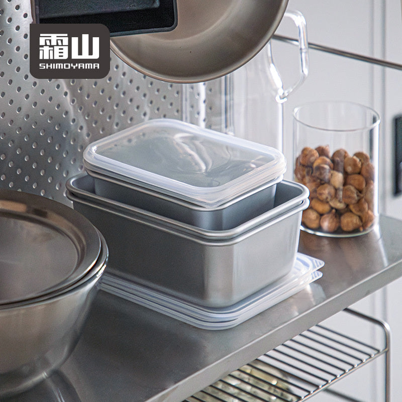 Stacked Shimoyama aluminum food containers with clear lids on stainless steel shelf