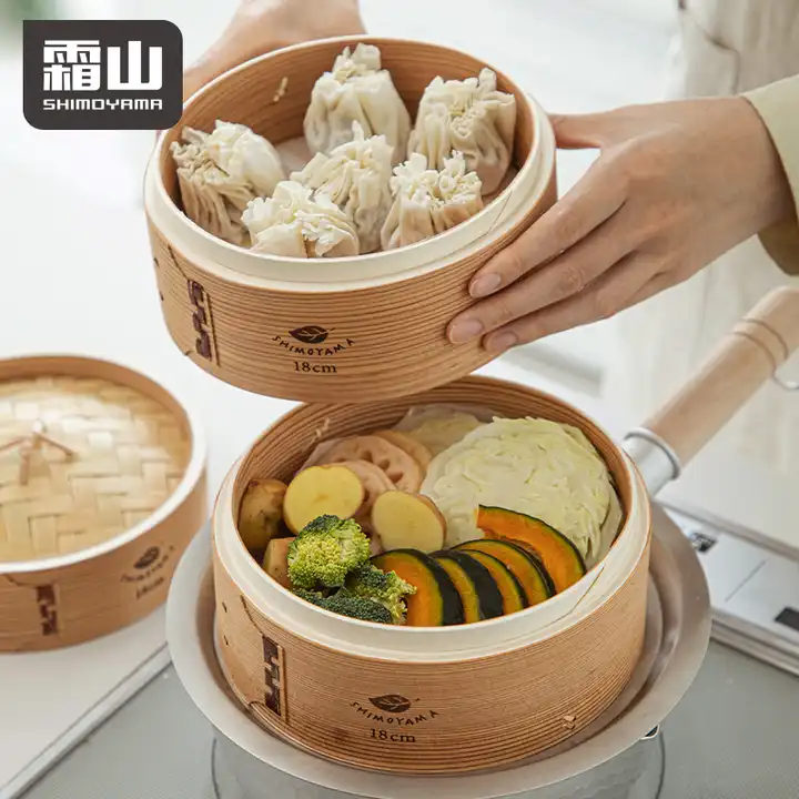 Two-tier Shimoyama bamboo steamer cooking dumplings and vegetables