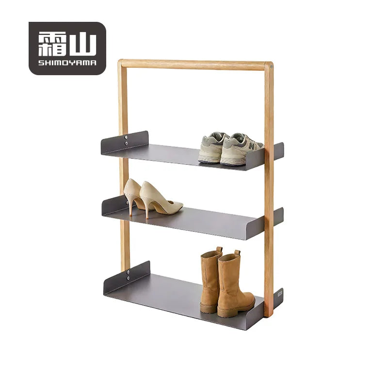 Shimoyama beech wood and steel three-tier shoe rack with grey sneakers, beige heels, and tan boots
