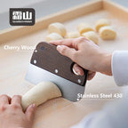 Close-up of Shimoyama bench scraper using cherry wood handle and 430 stainless steel blade to portion dough
