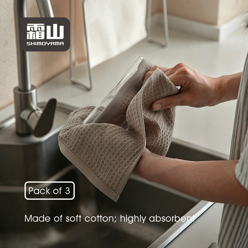Taupe waffle cotton dishcloth drying glass tumbler