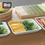 Enamel prep tray with tamagoyaki on wooden table