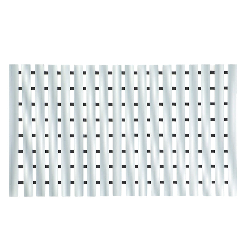 Flat lay of grey ribbed bath mat with black TPE anti-slip strips on white background