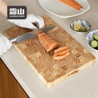 Slicing salmon on thick end-grain wooden chopping board