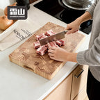 Chopping pork ribs on stable 4cm thick wooden board