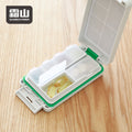Shimoyama green portable medicine box holding yellow softgel capsules