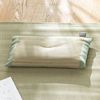 Sunlit close-up of olive green cotton edge and woven rush texture on pillow
