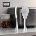 Clear textured TPX rice paddle standing upright on counter