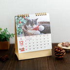 December page of the Life with Cats Mikan and Jiro Desk Calendar 2027 beside pine cones