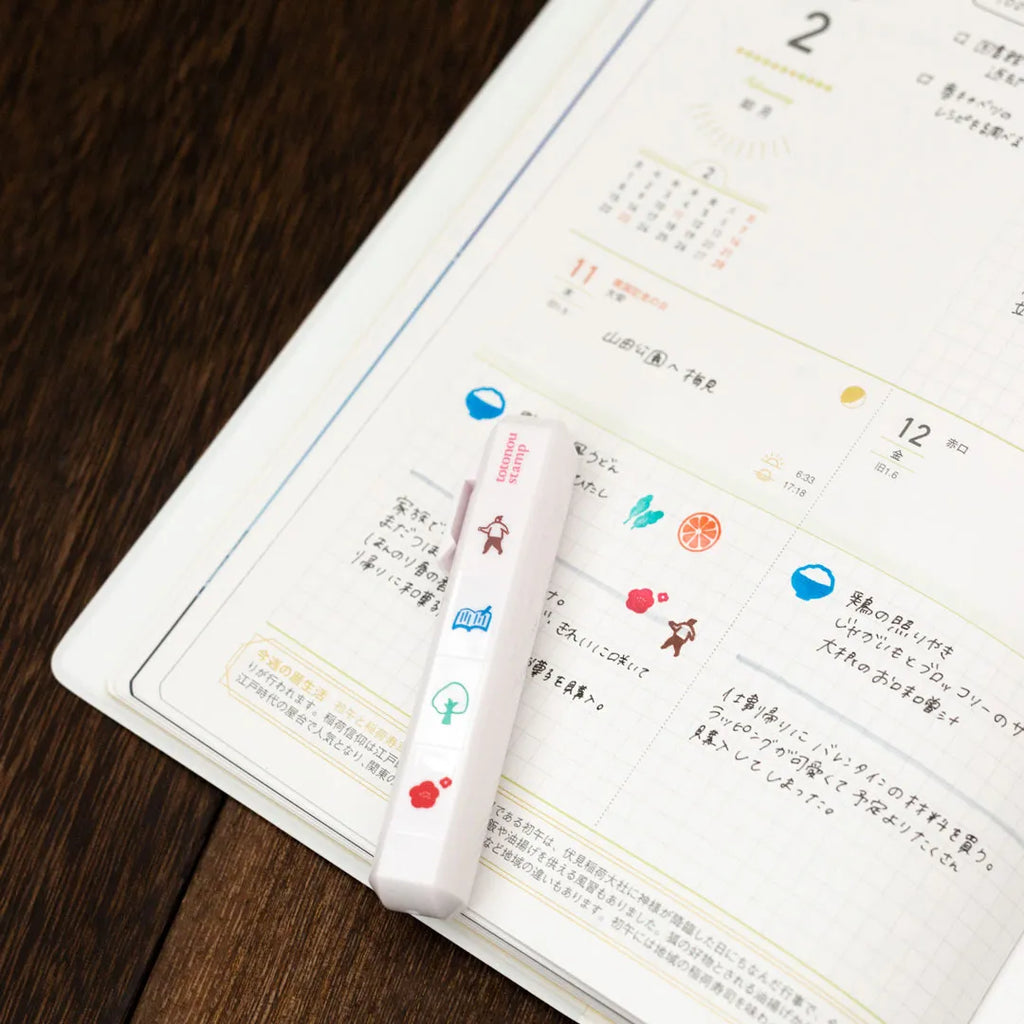 Totonofu Planner Stamps Finding the Seasons stick lying on an open planner