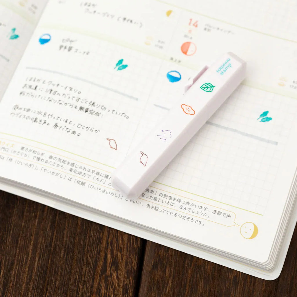 Totonofu Planner Stamps Joys of the Four Seasons stick lying on an open planner