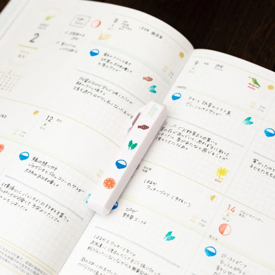 Totonofu Planner Stamps Seasonal Foods stick lying on an open planner